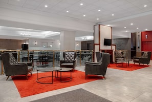 Relax in the hotel lobby's spacious seating area with leather armchairs and a coffee table.