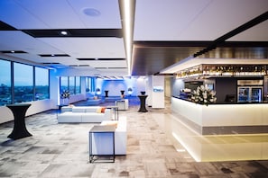 Relax in our spacious lobby with a seating area, bar, and stunning city views.