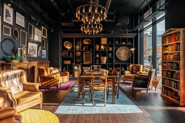 Relax in a warm and inviting space with a central dining area, comfortable seating, and a curated collection of decorative items.