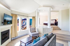 Relax in a spacious room with a comfortable seating area, flat-screen TV, and fireplace.