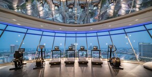 Work out with a city view at this gym featuring treadmills, stationary bikes, and a unique curved ceiling.