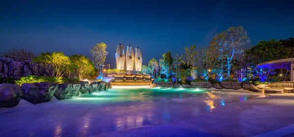 Experience the serene ambiance of our tranquil outdoor space, surrounded by natural elements and a sleek, contemporary building design.